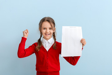 Wall Mural - Pupil with answer sheet for school test on color background