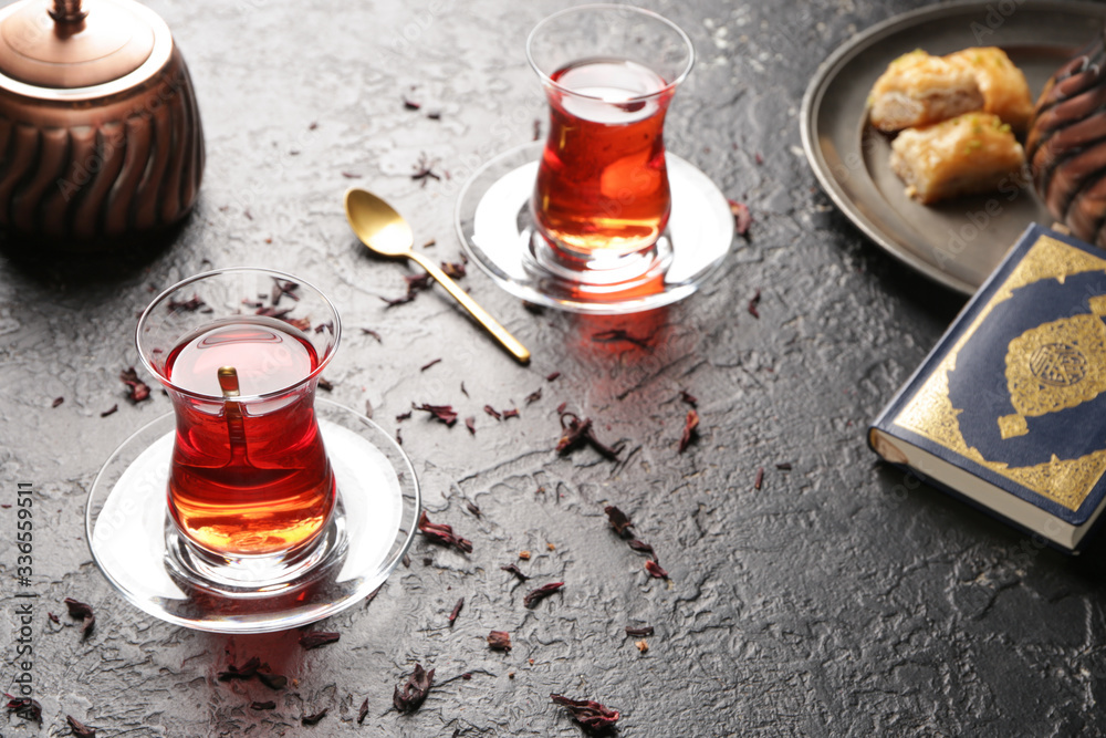 Glasses of tasty Turkish tea on dark background