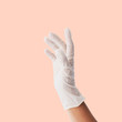 Hand wearing a white latex glove to prevent coronavirus contamination