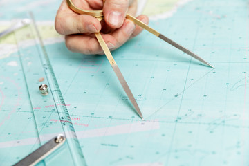 measuring distance on a sea chart tool. close-up. navigation in the maritime industry and yachting.