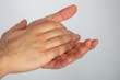 Closeup of rubbing hands with sanitizer on a white background, to prevent spread of coronavirus