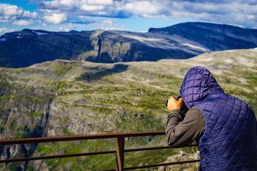 Wall Mural - Tourist taking photo in norwegian mountains