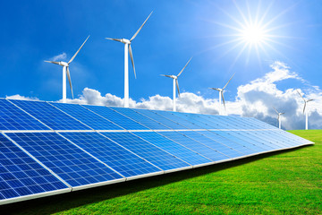 Solar panels with wind turbines on a sunny day,green clean energy concept.