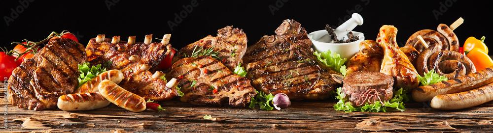 Various barbecued gourmet meats on timber board - obrazy, fototapety, plakaty 