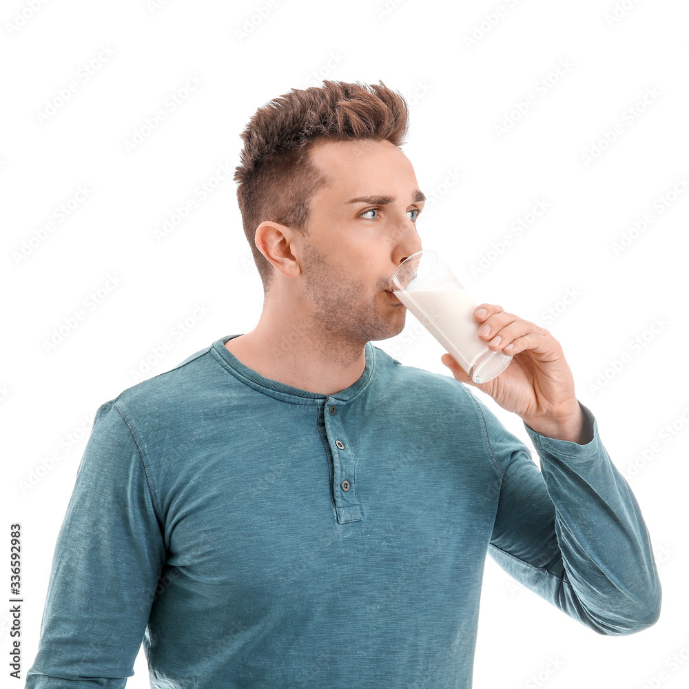 Young man with milk on white background