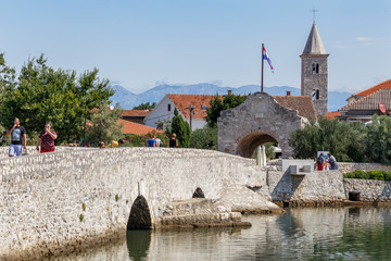 Wall Mural - NIN / CROATIA - AUGUST 2015: People on the medieval bridge to Nin town, Croatia