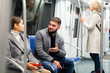 © JackF - Guy enjoying conversation with woman in subway train