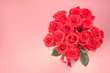 Bouquet of red roses on pink background