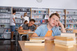 © JackF - Bored teenage boy in school library