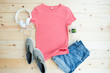 © photobuay - Pink female t shirt mock up flat lay on wooden background. Top front view Casual outfit flat lay fashion photography cozy environment top-down view lifestyle inspiration