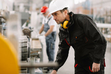 Colleagues working together. Workers in factory.