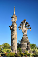 Standing Buddha Image and Buddha Image in attitude of Spreading Naga in Sala Kaeo Ku or Wat Khaek the famous place to travel in Nong Khai Province, Thailand