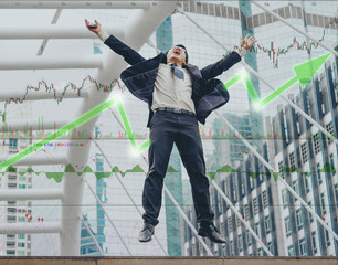 Happy Asian businessman jumping success from stock market gain much money from bullish market