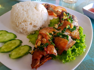 Cambodian chicken leg steak served with vegetables and steamed rice