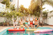 Group happy friends making pool party - Young people having fun celebrating carnival event in exclusive swimmingpool summer tropical vacation - Friendship and youth holidays lifestyle concept
