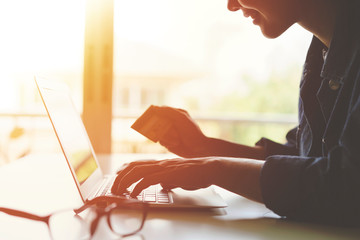 Online shopping concept,Hand holding a credit card and using laptop.