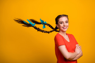 Wall Mural - Profile photo of pretty lady long braids blue ribbon bows flight arms crossed showing groomed hair after salon procedure wear casual red t-shirt isolated bright yellow color background