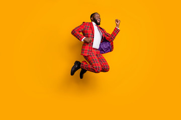 Wall Mural - Full length profile photo of crazy dark skin guy jump high up celebrate successful achievement wear plaid red costume blazer pants shoes isolated bright yellow color background
