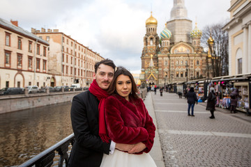 Happy lovely wedding couple posing on streets near cathedral