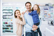 © zinkevych - Cheerful glad family posing in drugstore and looking happy