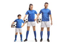 Young Man, Woman And A Boy In Sports Jersey Holding Soccer Balls
