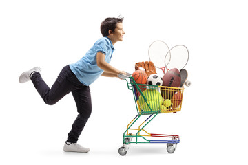 Poster - Boy running and pushing a small shopping cart full of sports equipment