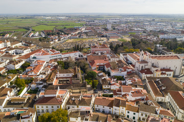 Evora drone aerial view on a sunny day with historic buildings city center and church in Alentejo, Portugal