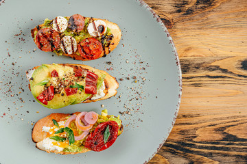 bruschettas with avocado tomatoes mozzarella sun-dried tomatoes and spices