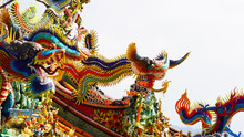 Bright Multi-colored Sculptures Of Japanese Samurai Dragons On The Roof Of Traditional Temples. Religion In Asia. A Religious Temple Rises Above A Chinese City. Korean Chinese Japanese Temples