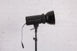 © fotodrobik - Large professional photo studio lamps on a white brick wall.