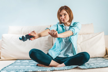 Portrait of a girl with a joystick in her hands. The concept of video games, computer consoles. Stay home.