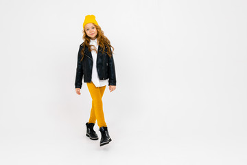 schoolgirl in a black leather jacket stands in full growth on a white isolated background