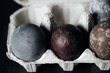 Easter eggs in eggs box, naturally dyed with red grape juice. Selective focus.