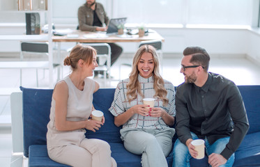 Poster - business team is discussing something sitting in the office lobby