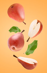 Wall Mural - Falling fresh pears isolated on red background