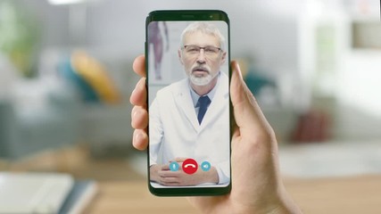 Point of View: Man Using Smartphone to Talk to His Doctor via Video Conference Medical App. Person Checks Symptoms, Talks with Physician, Using Online Video Chat Application. Close-up POV Camera
