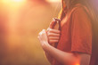 Girl holding a Bible tight as it is the only hope, beautiful warm color palette