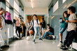 © Maskot - Boy playing with basketball during lunch break in school corridor