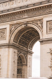 Fototapeta Paryż - Architectural fragment of Arc de Triomphe. Arc de Triomphe de l'Etoile on Charles de Gaulle Place is one of the most famous monuments in Paris.
