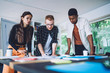 © BullRun - Diverse colleagues discussing data while working on draft