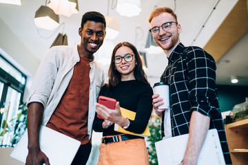 Wall Mural - Cheerful diverse colleagues looking at camera