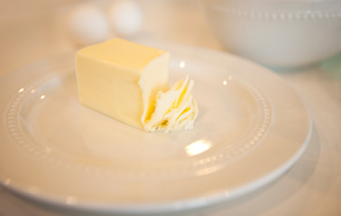 cube of butter sliced on a white plate