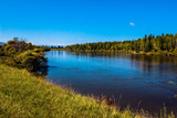 Fototapeta Na ścianę - 
Irkutsk region, Arshan, Irkut river. Green shores, blue sky and water