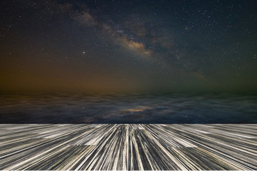 Wall Mural - wooden floor backdrop sky milky way reflection water floor at night