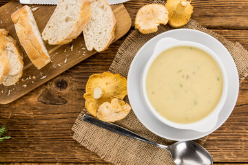 Canvas Print - Chanterelle Soup on wooden background; selective focus