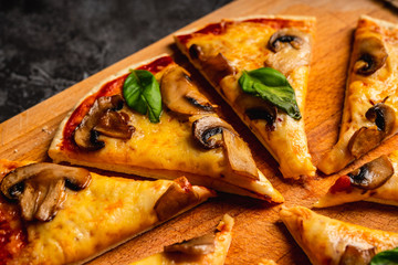 Wall Mural - Freshly making pizza with mushrooms served on the rustic background. Selective focus. Shallow depth of field.