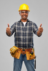 Poster - profession, construction and building - happy smiling indian worker or builder in helmet showing thumbs up over grey background