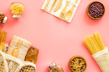 Wall Mural - Glass jars, cotton bags on pink background, top view. Eco friendly concept for kitchen - food storage copy space