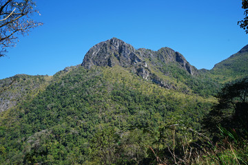 Natural landscape of rocky green mountain range view with clear blue sky