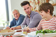 © Robert Kneschke - Family with grandfather and grandson having lunch